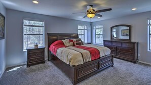 A bedroom with a large bed, a ceiling fan, and a dresser. - 3 Mi to Rainbow Lake: Home w/ Hot Tub & Deck (Pinetop-Lakeside)