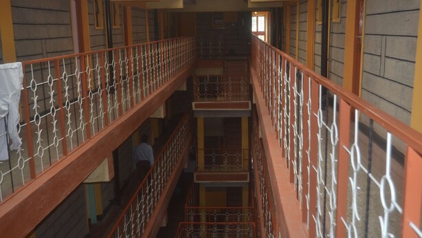 A multi-level interior with metal railings and wooden beams. - Maendeleo Parkview Hotel (Narok)