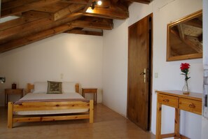 A bedroom with a wooden bed, a wooden nightstand, a wooden dresser, and a mirror on the wall. - 14 Aparts 150m. from the Sea & 6000 sq.m2 Garden–(36 to 42 pers, whole building) (Zakynthos)