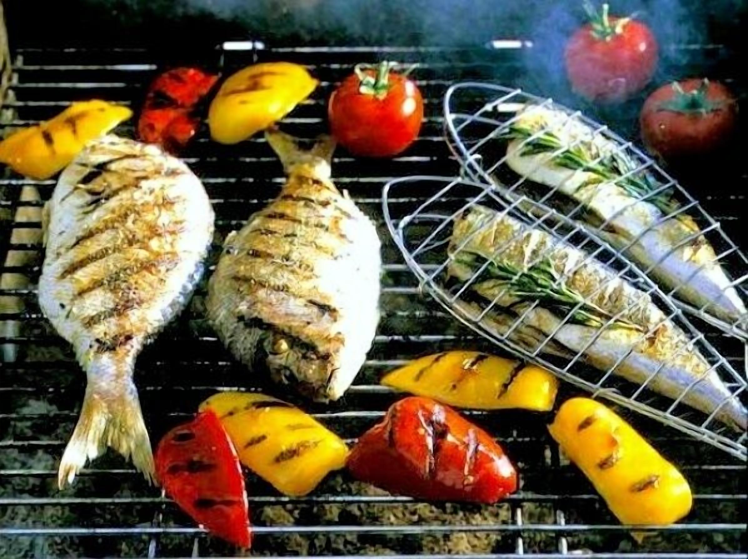 Grilled fish and vegetables on a grill.