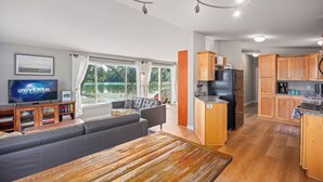 A modern kitchen with wooden cabinets, a built-in oven, and a refrigerator. - Unique Waterfront Beach House, 1 mile from Friday Harbor (Friday Harbor)