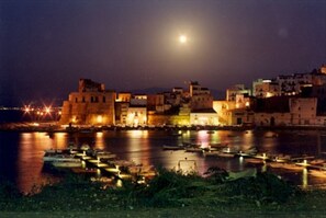 Stunning coastal town with a historic fortress and marina, offering breathtaking waterfront views.