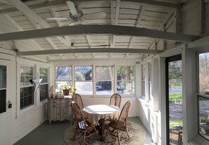 Bright and sunny dining area out on glassed in porch!