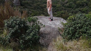 A person standing on a rock with a mountainous landscape in the background. - Patana holiday home (Kotapola)