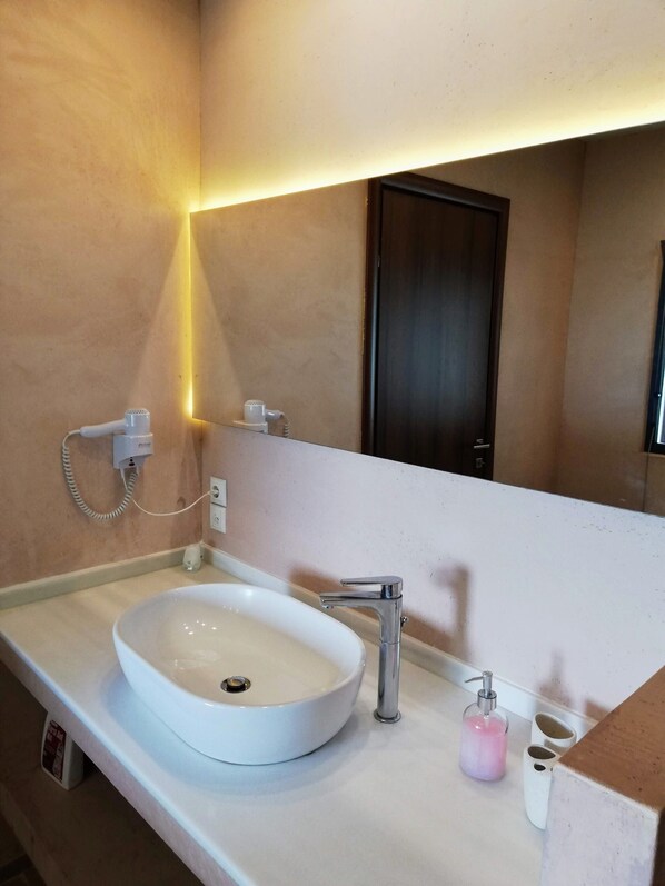 A bathroom with a white sink, a mirror, and a shower head. - 3 Br 2 Bth Superior Villa Cassiope with , Private Pool And Stunning Sea Views (Achladies)