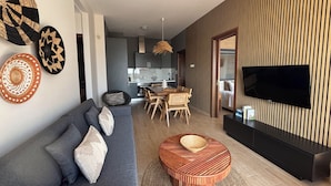A modern living room with a sofa, coffee table, and a dining area with chairs. - 3 Br 2 Bth Superior Villa  Cassiope with , Private Pool And Stunning Sea Views (Achladies)