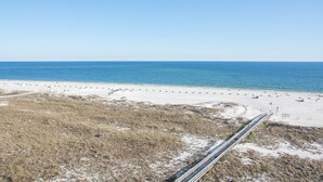 A beach with a sandy shore and a clear blue sky.