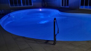 A swimming pool with a black ladder in the center, surrounded by a tiled floor. - Huge Indiana Family Reunion Villa with Indoor Pool, Hot Tub, Game Rm 8 BR, 7 BA (Winchester)