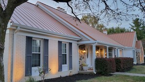 A two-story house with a sloped roof and a brick facade. - Huge Indiana Family Reunion Villa with Indoor Pool, Hot Tub, Game Rm 8 BR, 7 BA (Winchester)