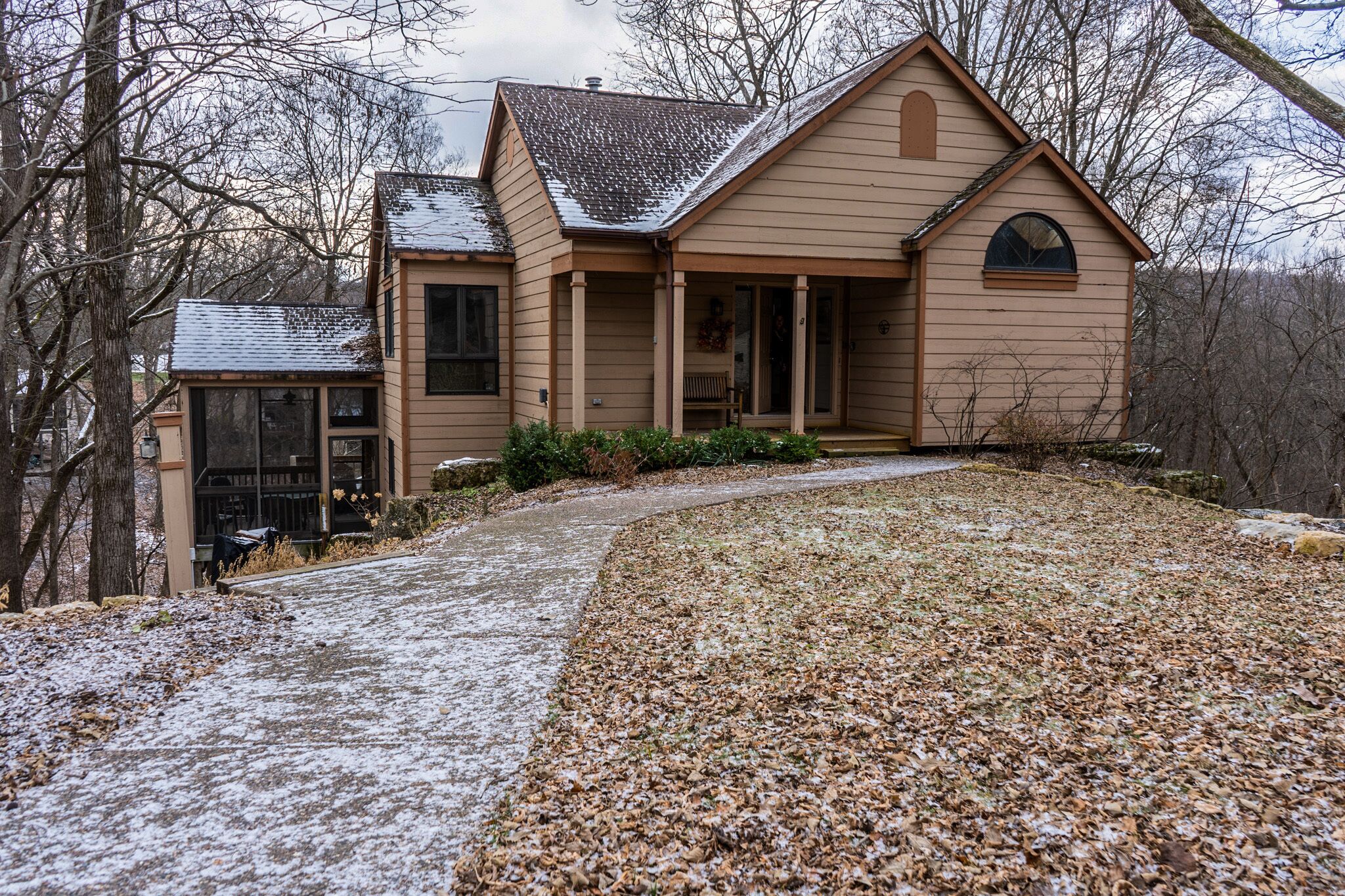 A two-story house with a covered porch and a garage.
