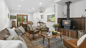A cozy living room with a fireplace, leather sofa, and wooden furniture. - Elderslie Country Estate - a stunning country house (Elderslie)