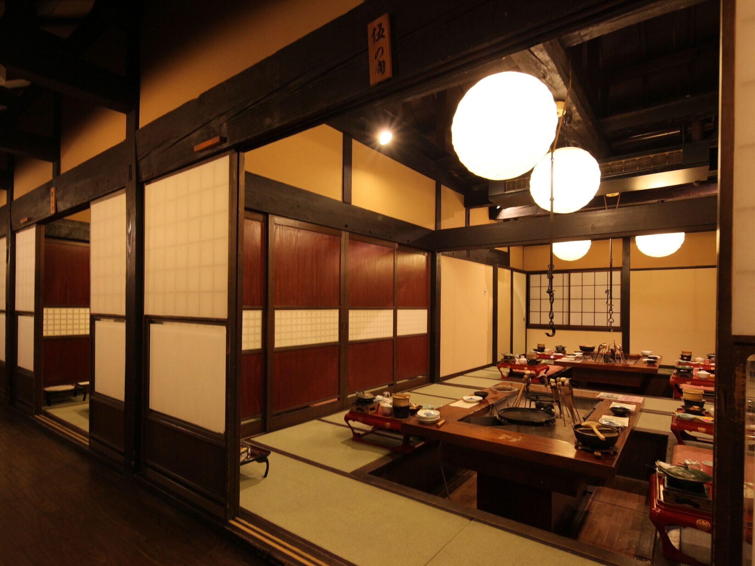 A traditional Japanese restaurant with tatami mat flooring and low tables.