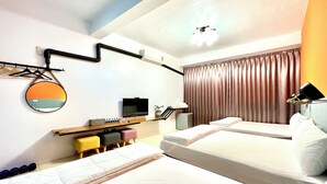 A hotel room with two beds, a TV, a desk with a computer, a mirror, and a ceiling fan. - Snug Nine Inn (Hengchun)