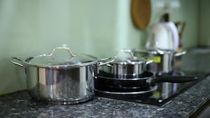 Stainless steel pots on a granite countertop. - Tuti Lakeside Homestay (Hanoi)