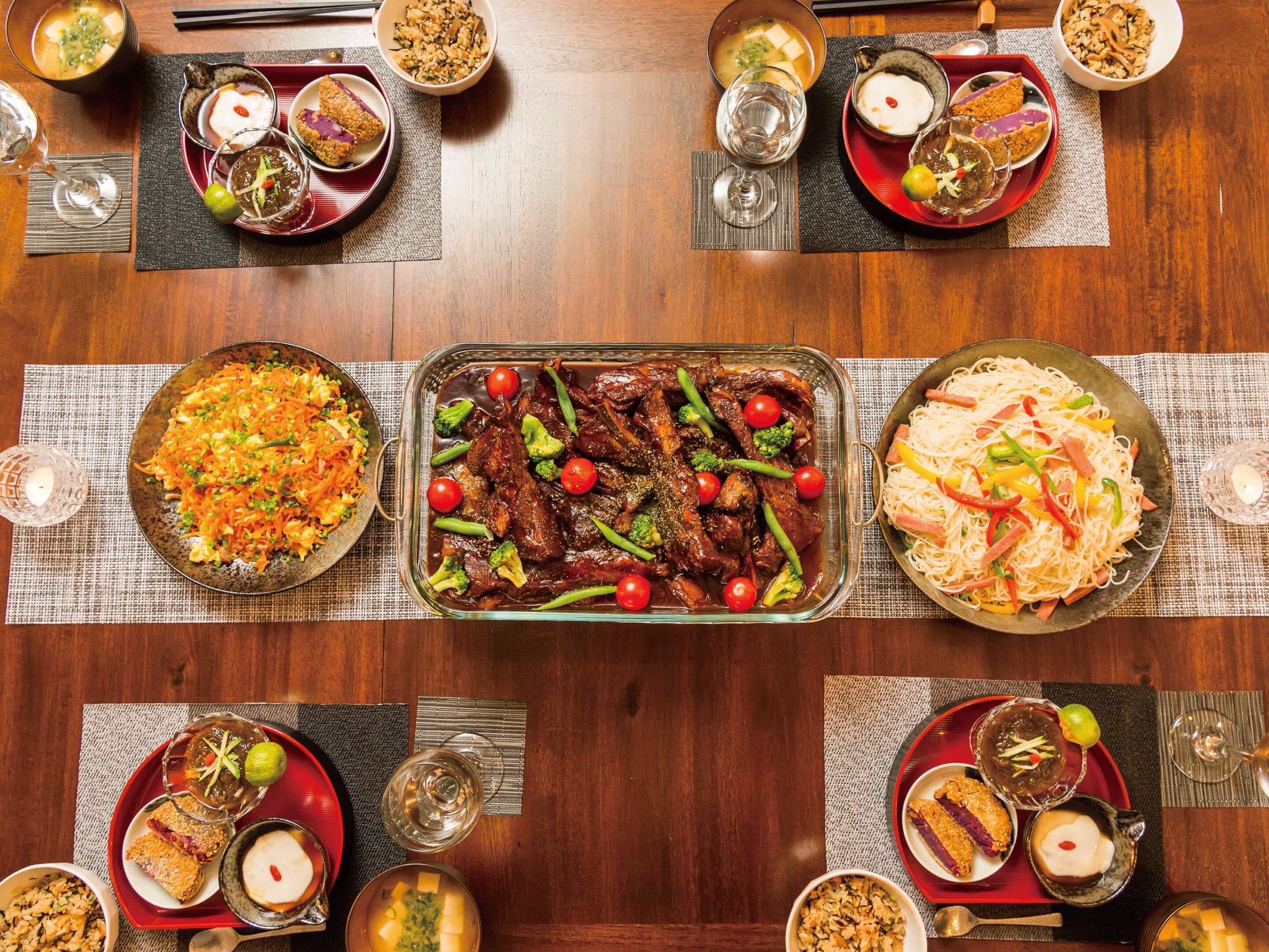 A dining table with various dishes and drinks, arranged for a meal.