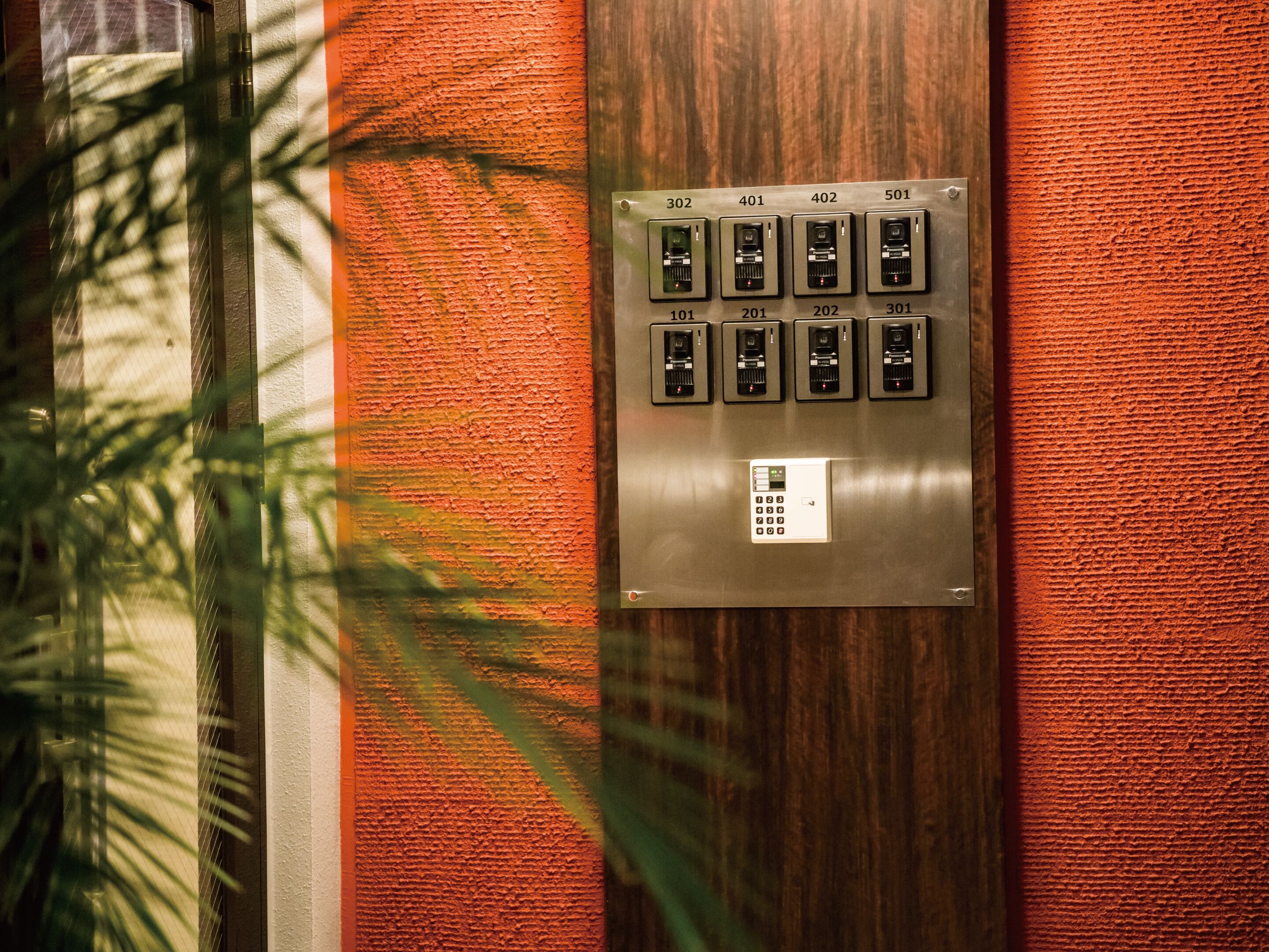 An elevator with a control panel featuring numbered buttons and a keypad.