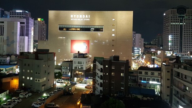 A modern building with a large Hyundai Department Store sign. - Midtown Hostel (Daegu)