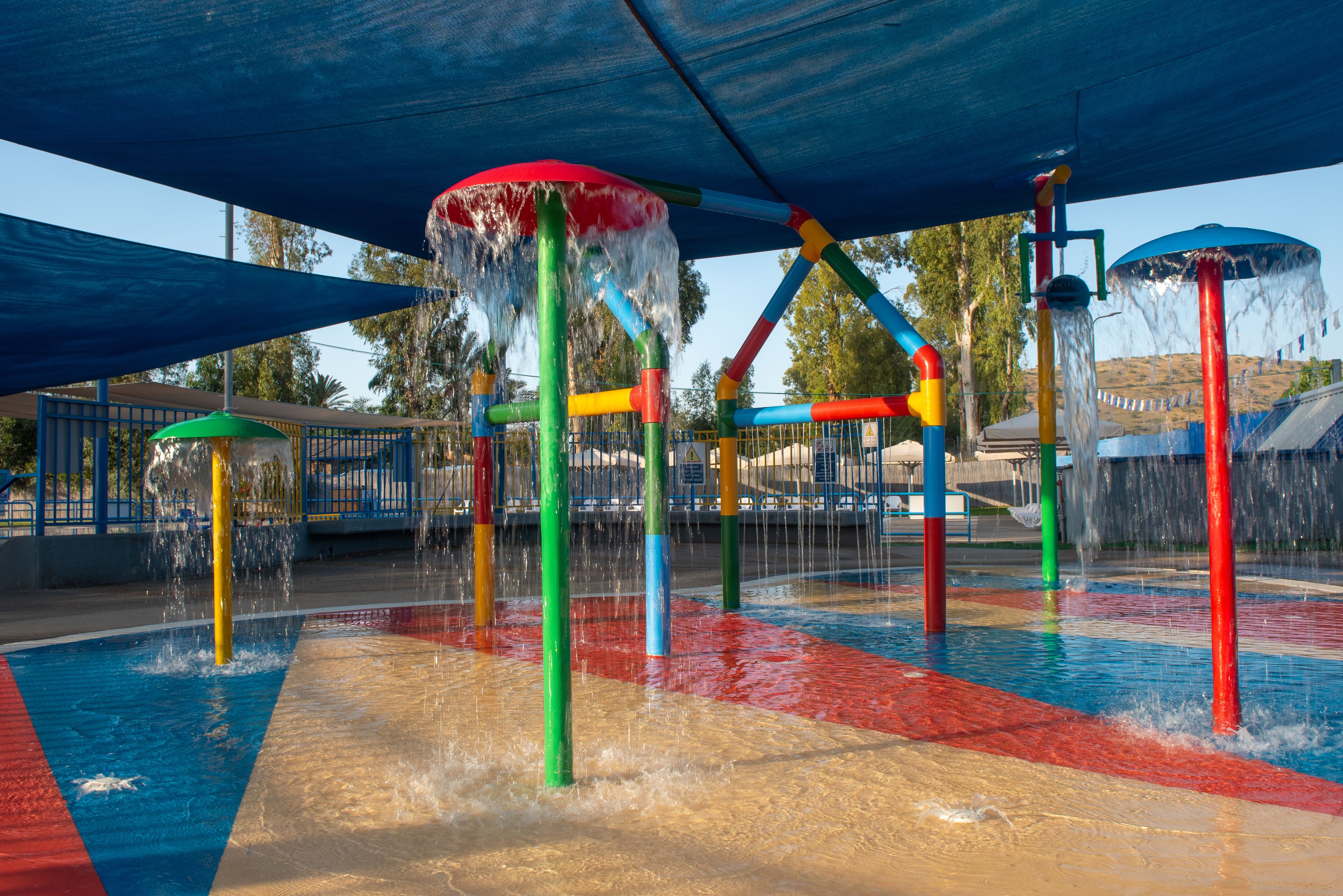 A water play area with multiple water jets and a covered section.