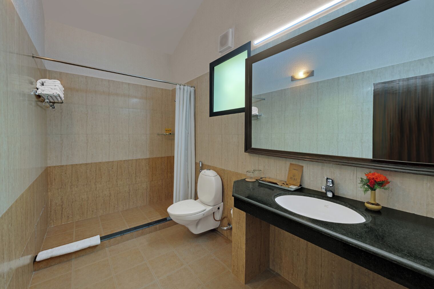 A modern bathroom with a shower, toilet, and sink.
