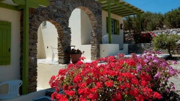 A building with stone arches and a covered patio area. - Asante Paros (Paros)