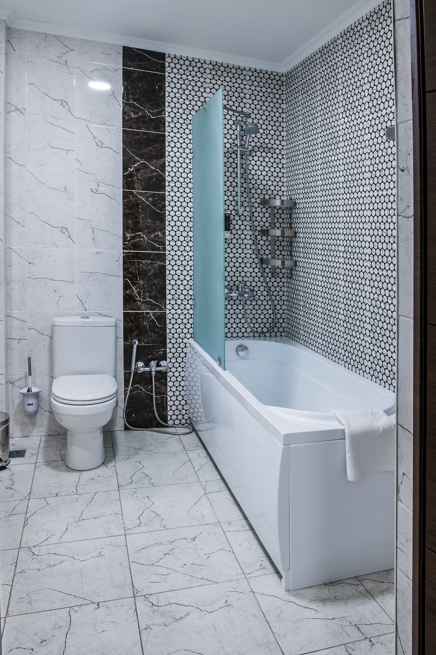 A bathroom with a toilet, a bathtub, and a shower.