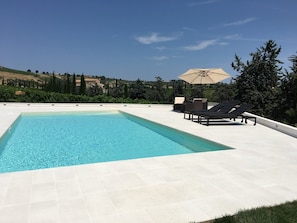 Seasonal outdoor pool, pool umbrellas, pool loungers