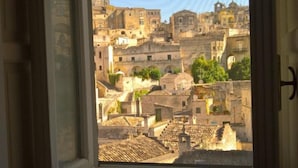 Una habitación con ventana que da a un paisaje urbano histórico.