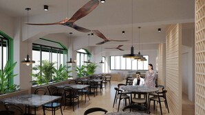 A modern restaurant interior with high ceilings, pendant lighting, and a variety of seating arrangements. - Grand Hotel Loutraki (Loutraki-Agioi Theodoroi)