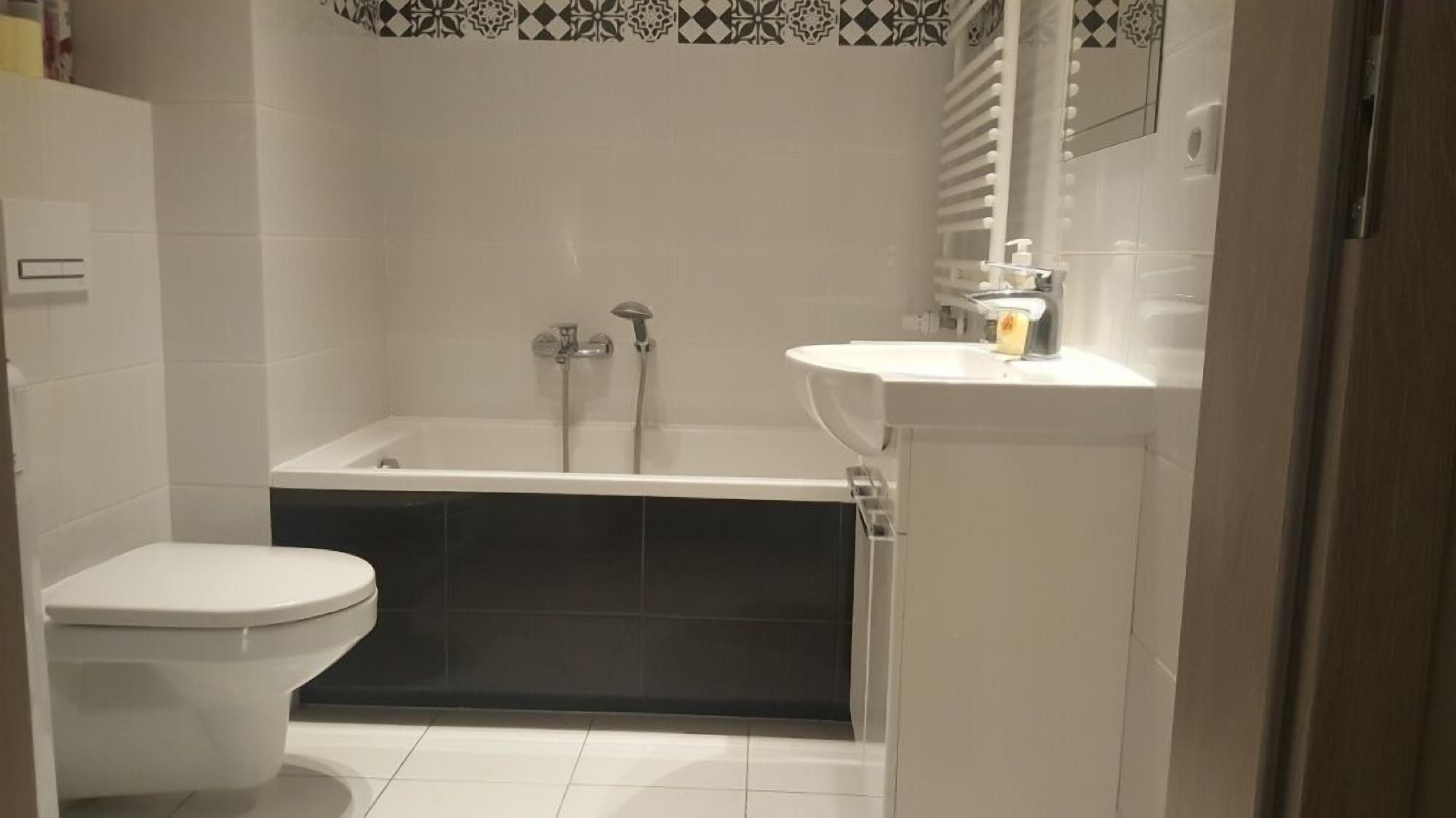 Un baño con inodoro, bañera y lavamanos.