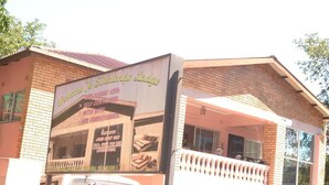 A building with a sign that reads "Welcome to Silalango Lodge" and mentions self-contained rooms.