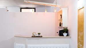 A modern kitchen with a white countertop, a built-in oven, and hanging pendant lights. - Olimpo B&B (Giurdignano)