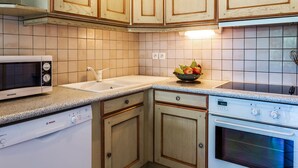 A kitchen with wooden cabinets, a microwave, a Siemens oven, and a Bosch dishwasher. - 2-Bedroom Duplex near Ski Slopes, Central Village, Parking, Balcony, La Clusaz (La Clusaz)