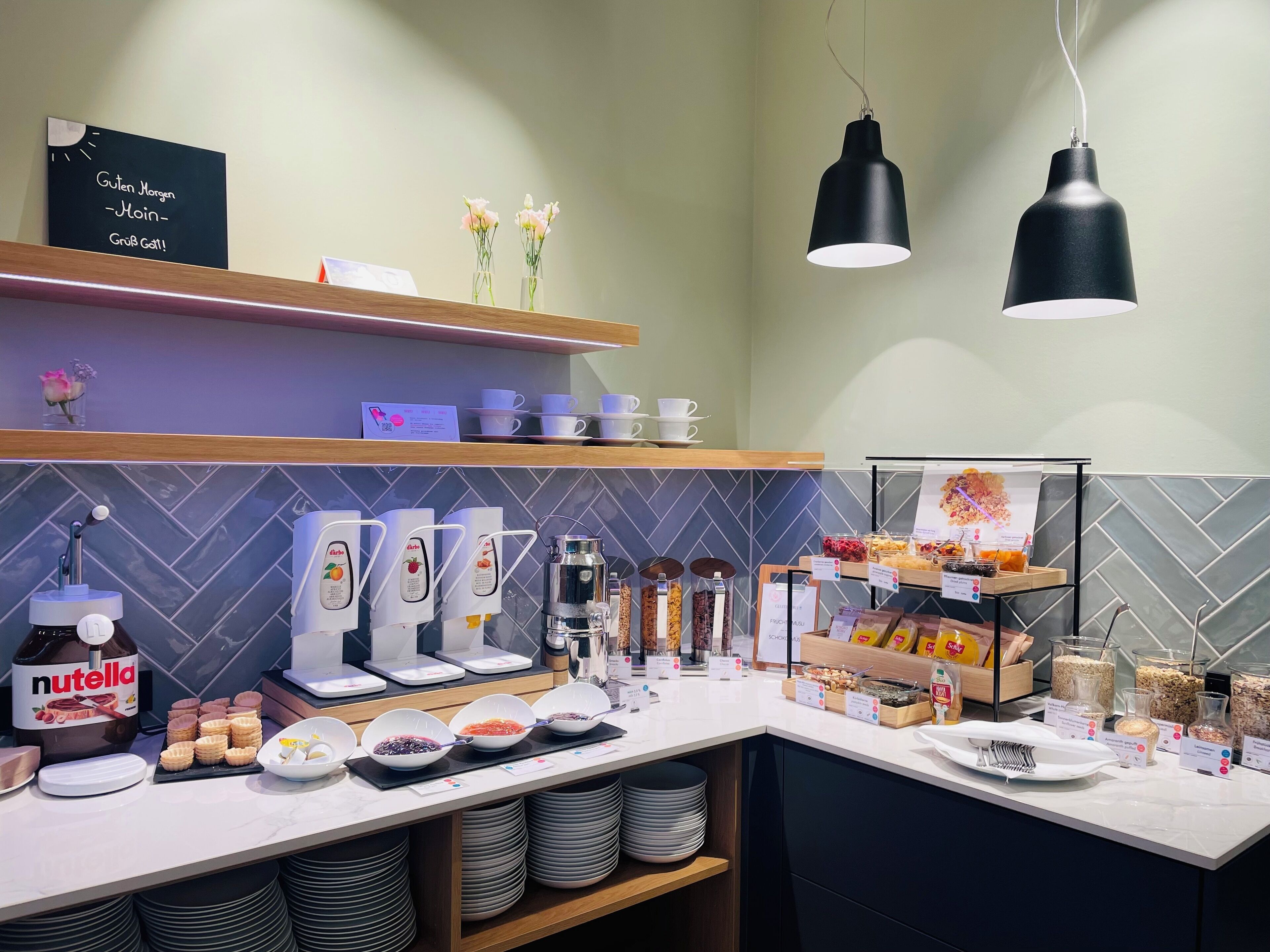 A breakfast bar with Nutella, waffles, and various condiments.