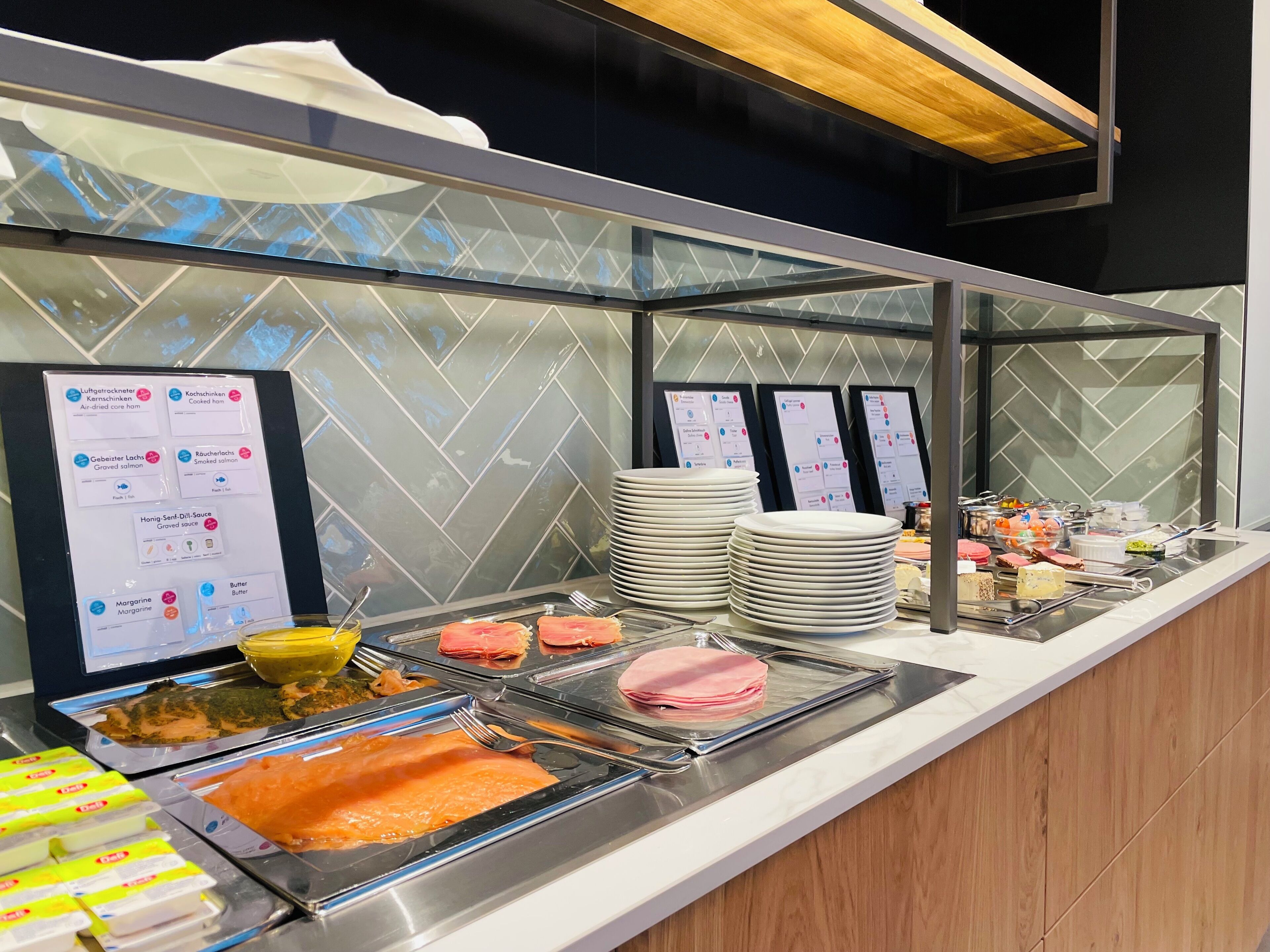 A buffet setup with various food items and condiments.