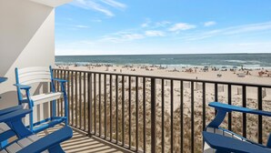 A balcony with a view of a beach and ocean.