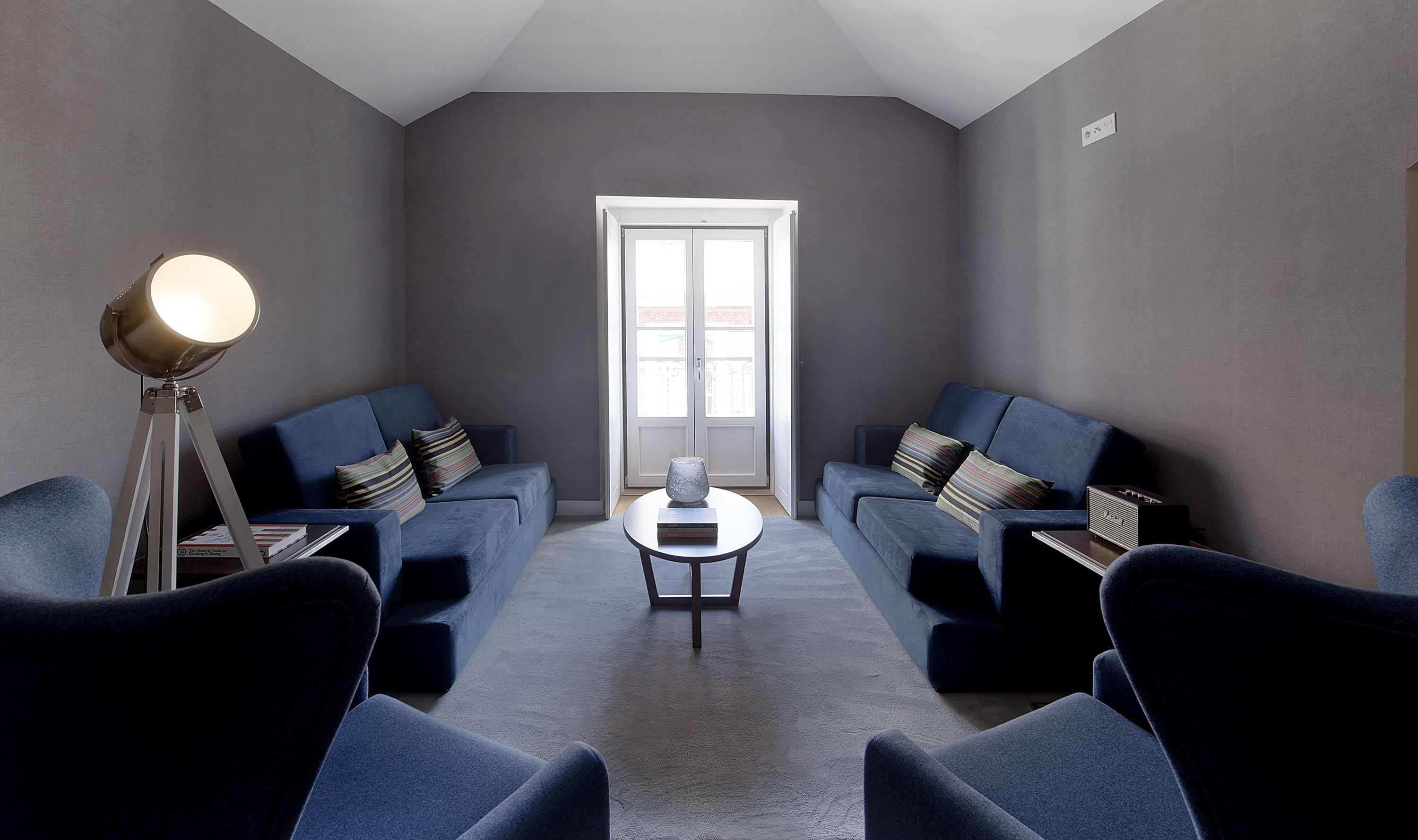 A modern living room with two sofas, a coffee table, and a floor lamp.