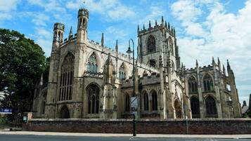 A historic Gothic-style building with intricate stonework and multiple towers.