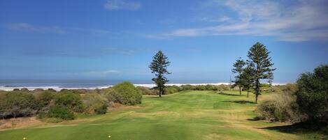 A golf course with a view of the ocean.