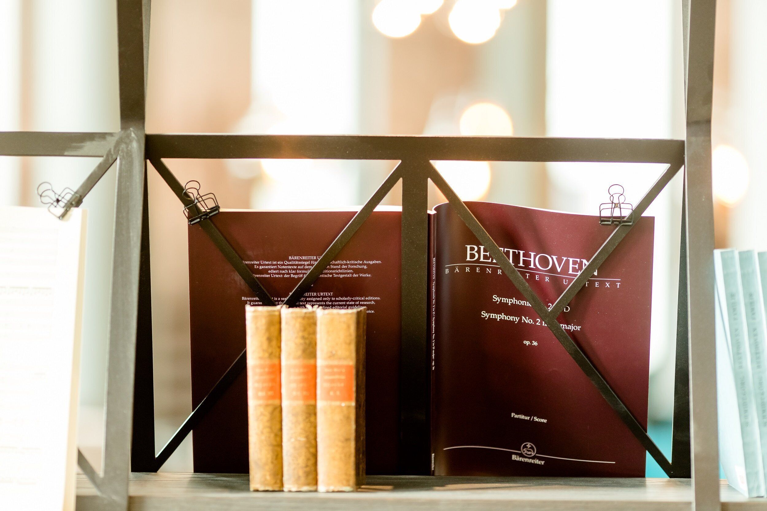 A bookshelf with books and binders.