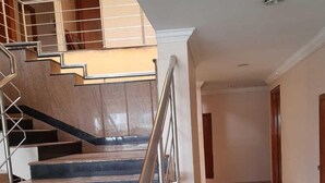A staircase with metal railings leading to an upper floor. - Hotel Janardana (Udupi)