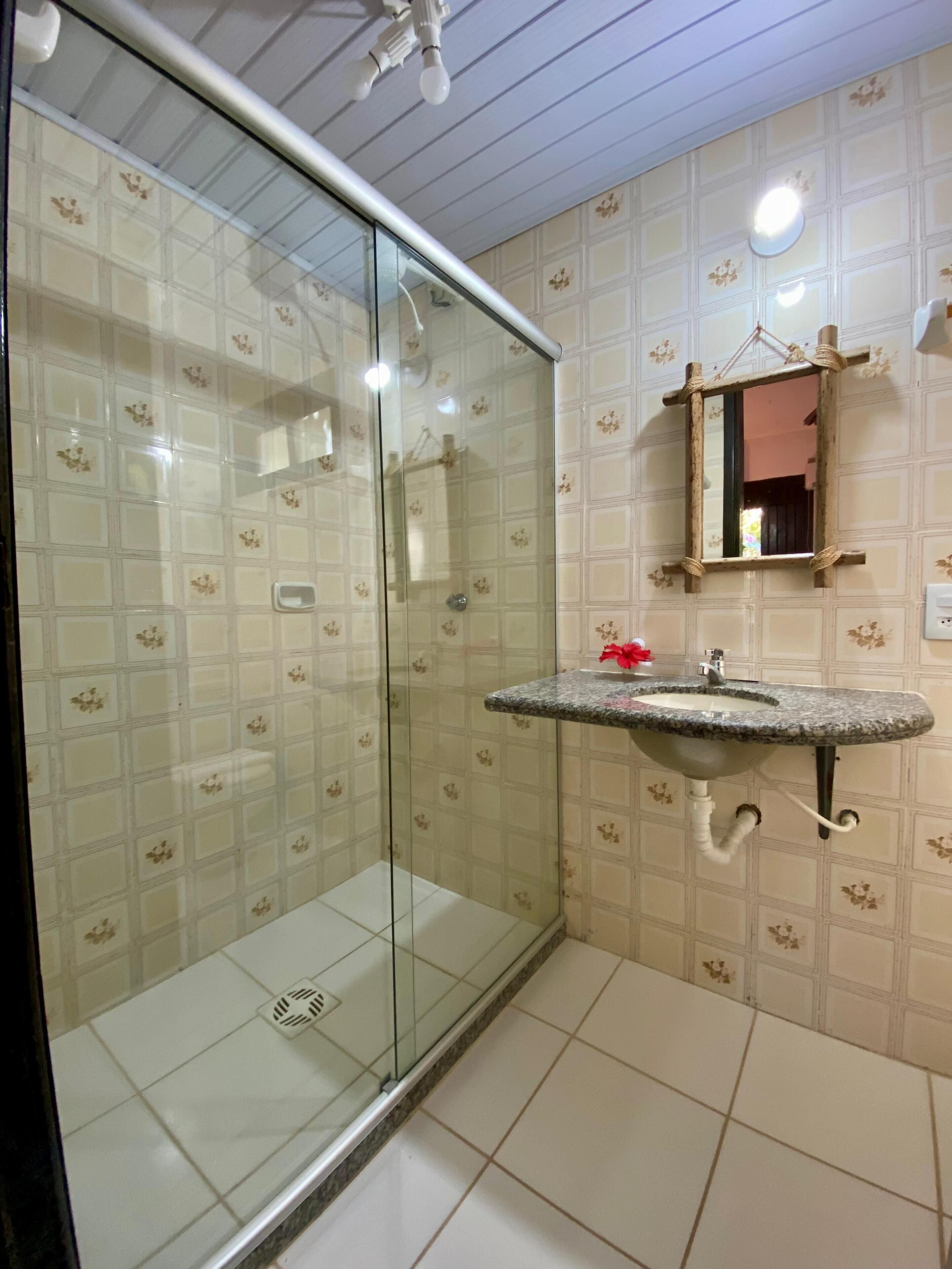 economy double or twin room, lanai, garden view | bathroom | shower, hair dryer, towels