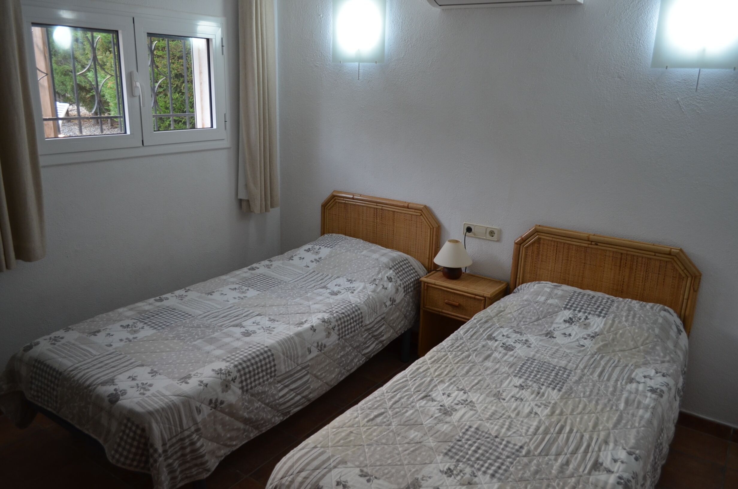 bedroom 2 with twin beds and views to pool.