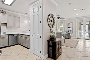 Enjoy a well-appointed space with a kitchen, living area, and dining area, featuring a sofa, coffee table, and table with chairs.