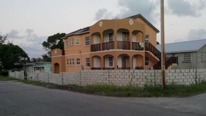 A two-story building with a balcony on the second floor. - Sand Dollar Vacation Apartment Rental (Mangrove)