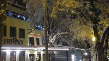 A hotel named 'FREDO' with a modern facade, large windows, and a visible entrance.