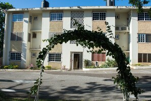 A multi-story building with a central entrance, windows, and a visible staircase. - Modern Bilton Apartment (Montego Bay)