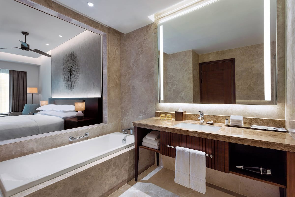 separate bathtub and shower, designer toiletries, hair dryer, slippers