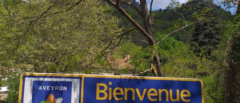 Un cartel de bienvenida a Aveyron, con un logotipo y texto.