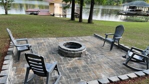 An outdoor patio with stone flooring, a circular fire pit, and four chairs. - Family  get away, pet friendly,fishing, boating and fun,  (Milledgeville)