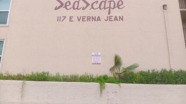Un bâtiment portant l’inscription « SeaScape » et l’adresse « 117 E. Verna Jean » sur sa façade.
